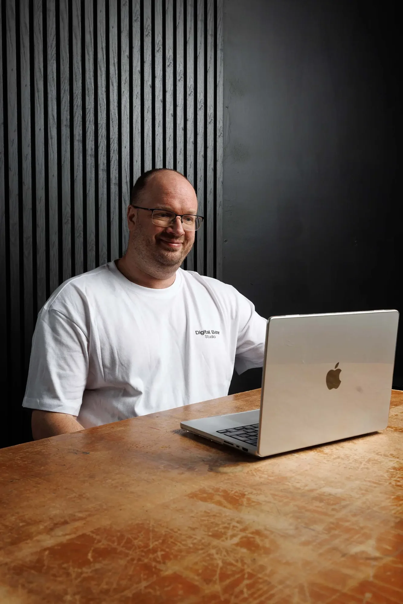 Adam, co-founder of digital bear studio on a laptop taking a client call for The Brand Intensive branding services